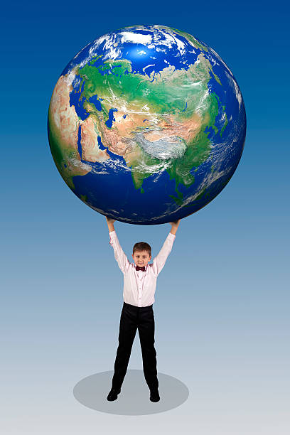 istock boy holding in his hands over his head large globe 464449750