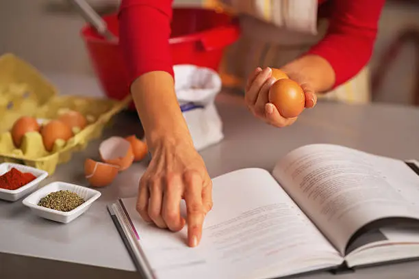 Photo of Closeup on happy housewife preparing christmas dinner in kitchen