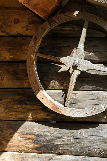 istock Wooden wheel on the wall 464454898