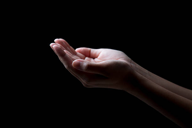 istock woman hands palms up over black background 464455320