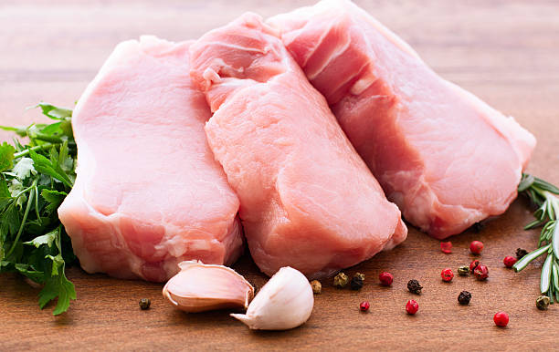 istock Raw pork meat on wooden desk 464456292