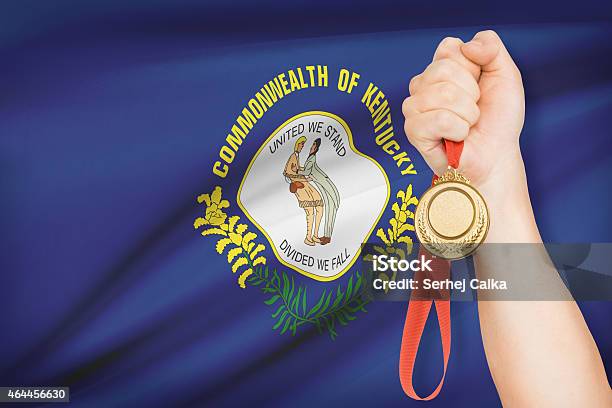 Medal In Hand With Flag On Background Kentucky Stock Photo - Download Image Now - 2015, Achievement, Armed Forces Rank