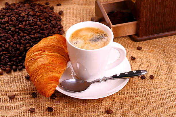 istock Coffee in white cup and croissant 464459439