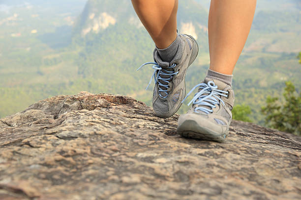 istock hiking woman legs climbing on mountain peak 464460006