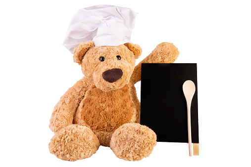 Teddy bear with slate board, isolated on white background.