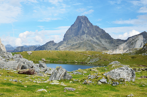 The alpine lake Casterau is photographed against the famous peak du Midi d'Ossau in the Atlantic Pyrenees, Bearn.