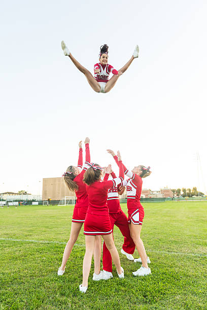 istock Group of Cheerleaders Performing Stunts 464460303