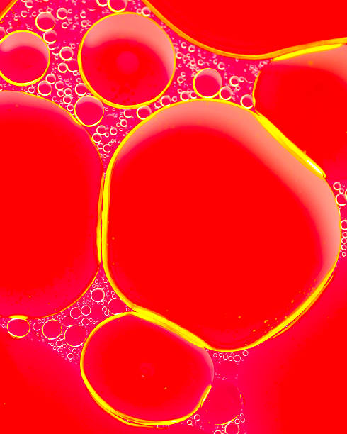 istock Red and yellow oil droplets in water 464461786