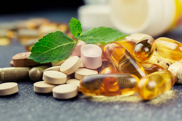pills and multivitamins pills and multivitamins on a dark background, closeup nutritional supplement photos stock pictures, royalty-free photos & images