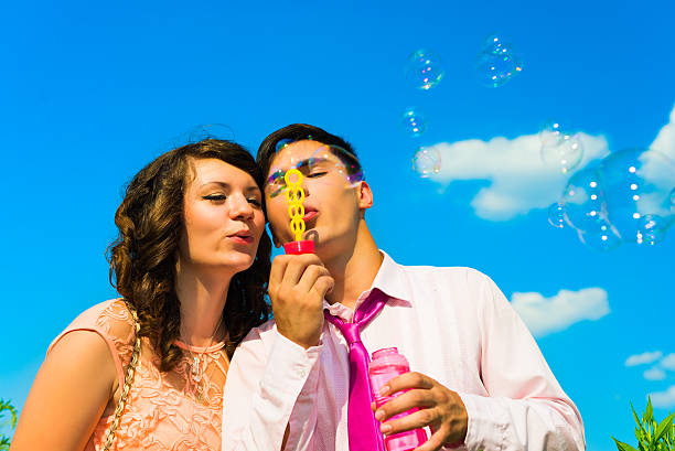 istock The young happy couple  with soapy bubbles. 464479928