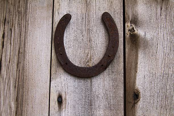 istock textured wood background with old horseshoe 464479946