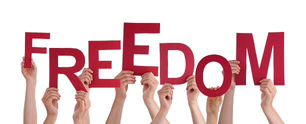 istock Many People Hands Holding Red Word Freedom 464480184