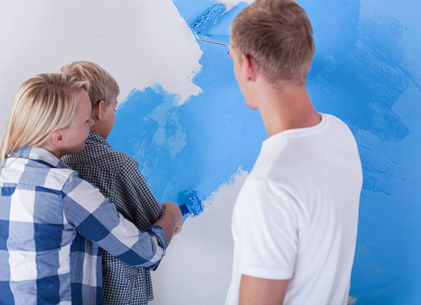 istock Little boy painting wall 464480318