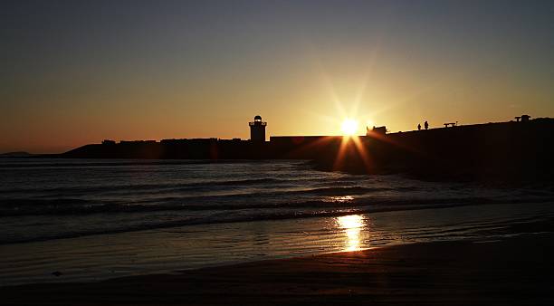istock Lighthouse and sea at sunset 464481118
