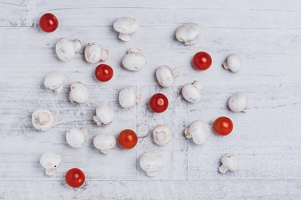 Button mushrooms and cherry tomatoes stock photo