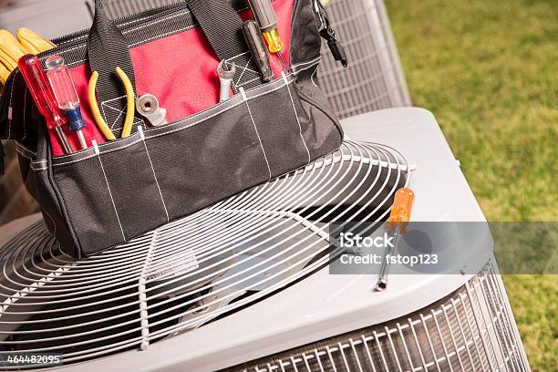 Service Industry Work Tools On Air Conditioners Outside Home Stock Photo - Download Image Now