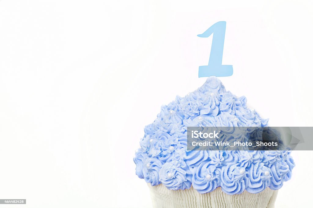 First Birthday Giant Blue Cup Cake Giant beautifully decorated Blue cup cake on white background 2015 Stock Photo