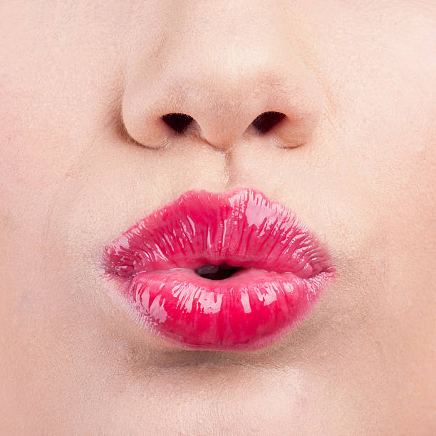 istock Close up of womans pouting lips with red lipstick 464484748