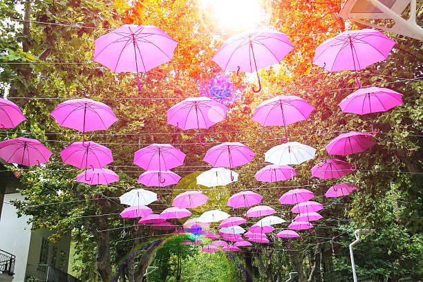 Pink and white umbrellas decorate streets in the resort town Bellaria Igea Marina, Rimini, Italy