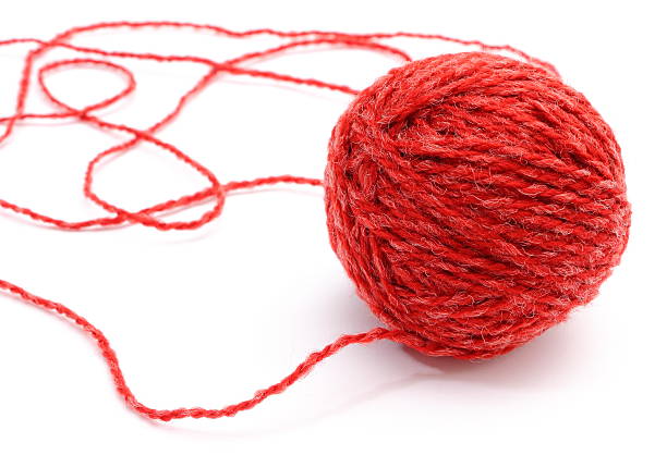 istock Closeup of entangled red wool on white background 464485276