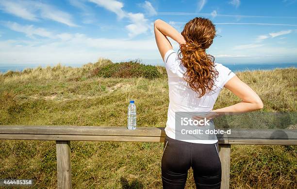 Athletic Woman Touching Neck And Back Muscles By Injury Stock Photo - Download Image Now