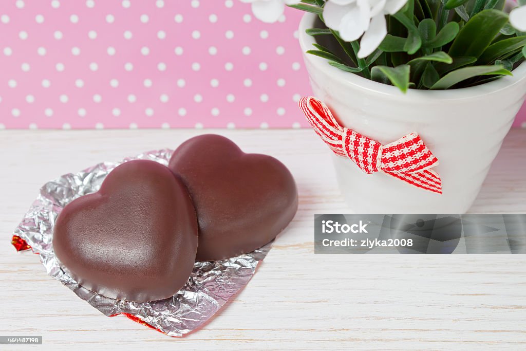 chocolate candy hearts two chocolate candy hearts on a wooden background, valentines day 2015 Stock Photo