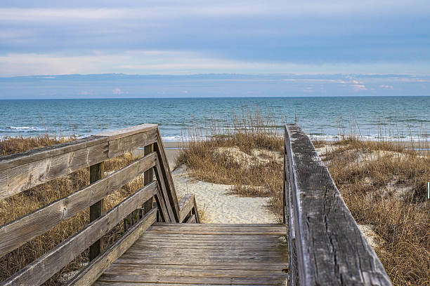 The Way To The Beach Worn wooden staircase leads to a wide sandy beach along the Atlantic coast. hilton head stock pictures, royalty-free photos & images