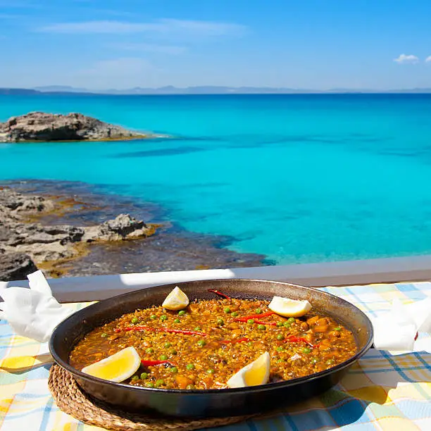 Paella mediterranean rice food by the Balearic Formentera island beach