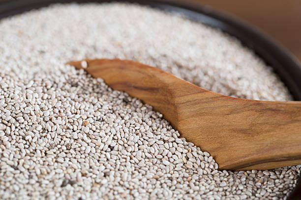 Healthy Chia Seeds Healthy white chia seeds in bowl with wooden spoon. salvia hispanica plant stock pictures, royalty-free photos & images