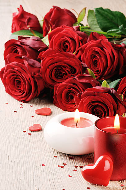 istock Red roses and candles in St Valentine's setting 464491262