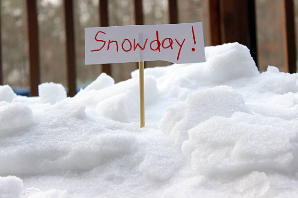 Snow Day Represented by Child’s Sign Planted in a Snowdrift