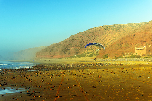 Sidi Ifni, Morocco - March 25, 2014:Parachutist on the coast of Sidi Ifni, Atlantic Ocean,Morocco