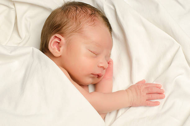 istock New born baby boy sleeping. 464492252