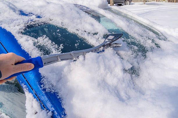 istock Snow removal from car body 464493486