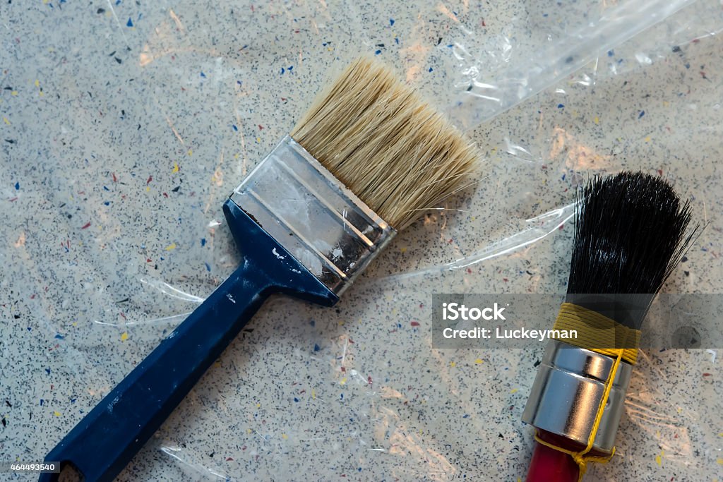 Two paint brushes on plastic underground 2015 Stock Photo