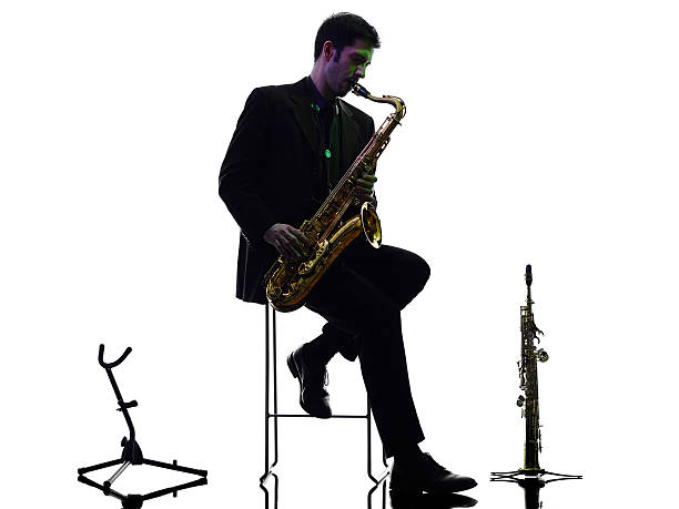 istock man saxophonist playing saxophone player  silhouette 464493864