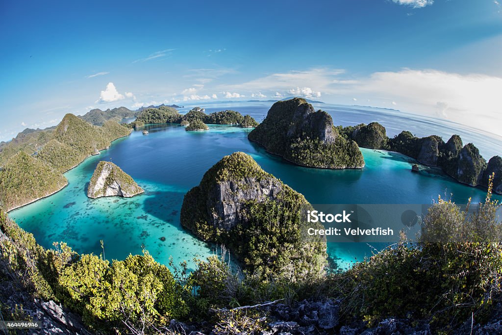Limestone Islands and Tropical Lagoon A gorgeous lagoon is surrounded by limestone islands in Wayag, Raja Ampat, Indonesia. This beautiful area is known for its high marine biodiversity and excellent scuba diving and snorkeling. Papua Province - Indonesia Stock Photo