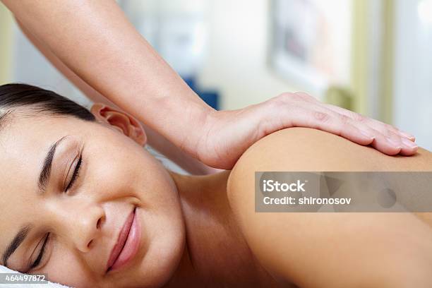 Smiling Woman Receiving A Back Massage Stock Photo - Download Image Now - 2015, Adult, Adults Only