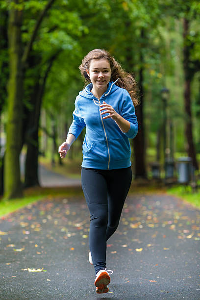 istock Young woman running outdoor 464499058