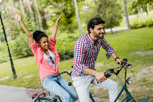 istock Young couple riding on the tandem bicycle 464500766