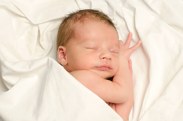 istock New born baby boy sleeping. 464502344