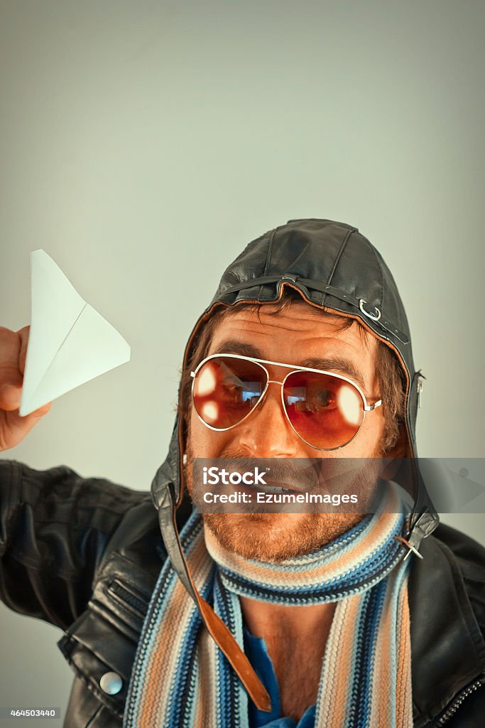 Aviator Man Paper Plane Aviator pilot with hat and sunglasses plays with paper planes Aviator Glasses Stock Photo