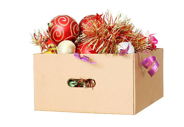 Christmas Decorations in a cardboard box Christmas Decorations packed away in a cardboard box christmas decoration storage stock pictures, royalty-free photos & images