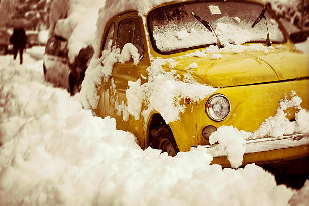 Car blocked ion the street n snow storm, Italy. Toned image.