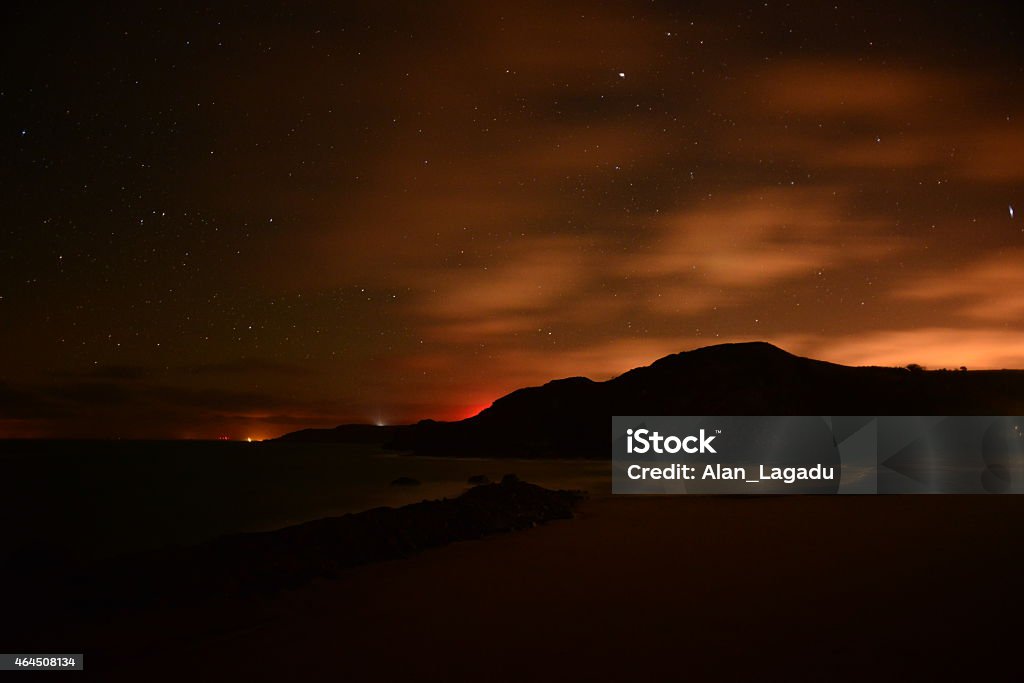 Greve De Lecq, Jersey, U.K. Wide angle astrophotography image using a long exposure and high ISO, of a small fishing port at night. 2015 Stock Photo