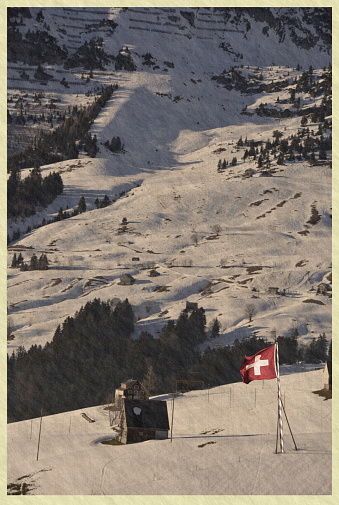 Swiss flag - national symbol of Switzerland with Alps in background. retro