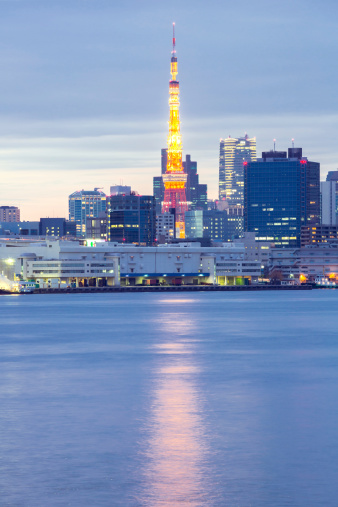 Tokyo Tower with skyline at dusk from Odaiba park in Japan