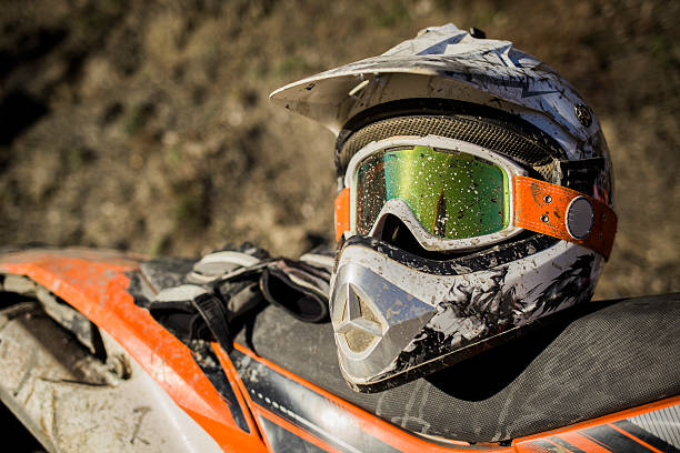 Dirty motorcycle motocross helmet with goggles Offroad adventure motorcycle enduro trip protection helm glasses off road vehicle photos stock pictures, royalty-free photos & images