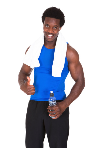 Portrait Of Young African Athlete Holding Water Bottle In Hand After Exercising