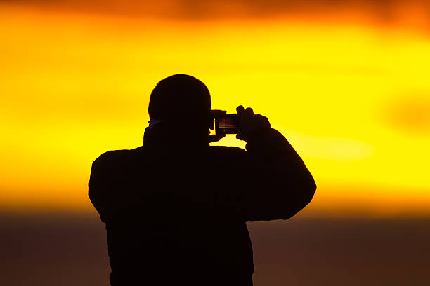 istock Photogrpher photographs sunrise 464520932